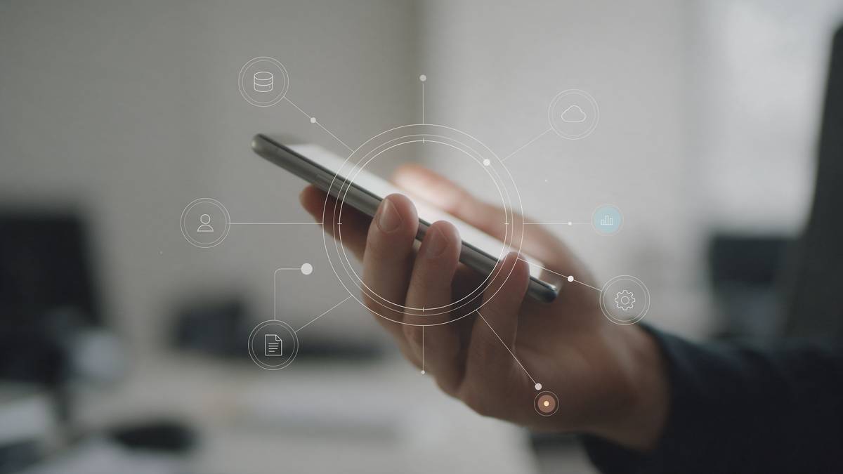 Hand holding a phone with data icons